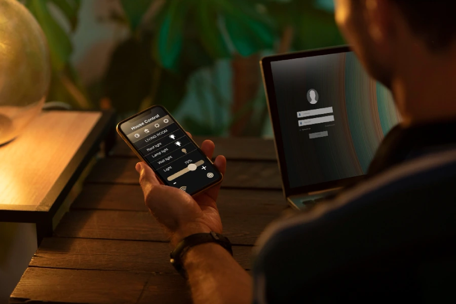person using smartphone his automated home